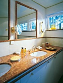 Sink table with marble clad, mirror and art decor fittings in bathroom