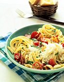 Spaghetti with tomato and garlic in green bowl
