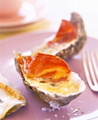 Close-up of beaten eggs with ham on oysters