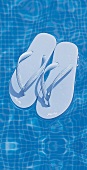Hellblaue flip-flop-Sandalen schwimmen im Pool