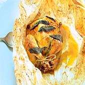 Close-up of guinea fowl cooked and served in parchment