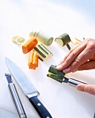 Close-up of man's hands carving vegetables with a cutter