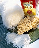 Close-up of rice, rice noodles and wheat noodles on banana leaf, Asian ingredients