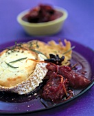 Close-up of toasted goat cheese and hash browns with plum chutney