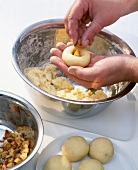 Close-up of man's hands filling potato dumpling
