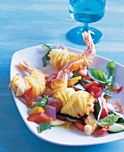 Close-up of shrimp wrapped in potato with diced peppers and courgettes