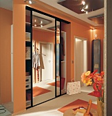 Cloakroom cupboard with mirror sliding door in hallway