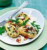Potato rolls with tomato, rocket leaves and parmesan on plate