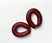 Two sausages on white background