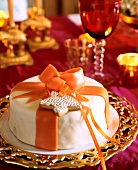 Almond cake decorated with star shape biscuit and marzipan ribbons