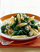 Penne with spinach and gorgonzola cheese on plate