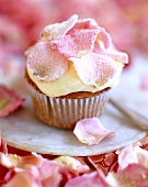 Close-up of muffin with vanilla cream and rose petals