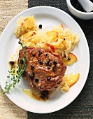 Chops with juniper, apple and cabbage served in plate