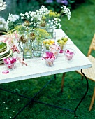 Table decorated with glasses, yarrow and dill rose petals