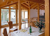 View of living area under wooden roof overlooking winter garden