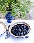 Ein Teller mit Blaubeeren, Heidel- beeren, Vase