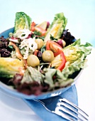 Cretan salad with olives and peppers in blue bowl