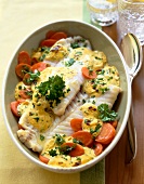 Mustard pollock with carrots in serving dish