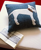 Blue cushion cover made of felt with sewn dog motif
