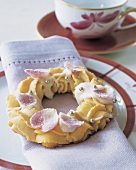 Christmas sweets decorated with heart shaped icing and golden beads on folded napkin