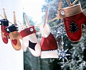 Gloves and hat of felt with star of glass beads hanging on rope