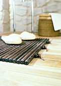 Close-up of slippers on wooden floor mat on parquet