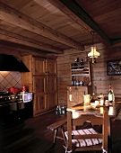 View of kitchen area with rustic dinning and wooden ceiling, walls and floor