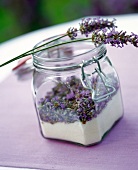 Lavender sugar in glass with stems of lavender