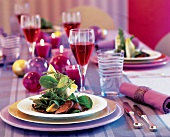 Lentil salad with fried turkey liver and lettuce on plate on festively decorated table