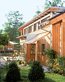 Exterior of house with wooden panelling and deep eaves