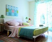 Bedroom with bed, fabric, blanket, checks carpet and curtains in pastels