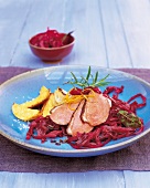 Marinated duck breast with red cabbage on plate