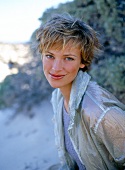 Portrait of pretty woman with short hair wearing jacket, smiling