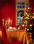 Festive table with red and golden decorations for Christmas