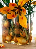 Close-up of vase with onions and yellow tulip