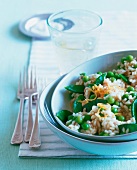 Risotto with peas and mangetout parmesan in ceramic bowl