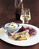Turkey saltimbocca with red cabbage and bowl of raisin rice on plate
