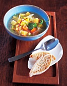 Bowl of Asian rutabaga stew on wooden tray