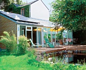 Conservatory house with adjoining terrace and pond