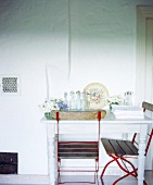 Farmhouse with table and old garden chairs