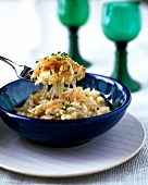 Cheese spaetzle in bowl with spoon