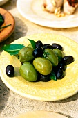 Green and black olives served on plate