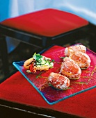 Tempura with prawns and eggplant chips on glass plate