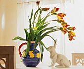 Tulips in vase on table with white dekohase