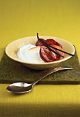 Quark cream with halved plums in bowl