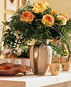 Yellow roses with leaves in precious vase