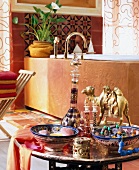 Bathroom with oriental accessories on table in front of bath