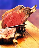 Close-up of cooked beef sliced on chopping board