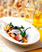 Close-up of bacalao salad with peppers in serving dish