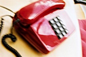 Close-up of red telephone, blurred